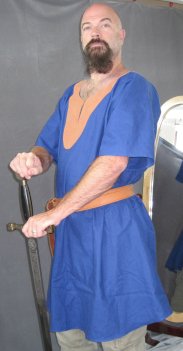 Man in blue tunic with tan leather ring belt available up to 72 inches length