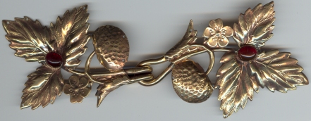 bronze strawberry leaf with red stone clasp