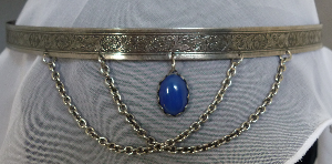 Silver-tone scrollwork band with blue center drop & drapes