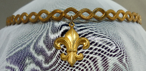 Gold-tone braid with fleur de lys dangle