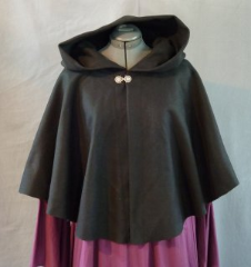 Cloak:1943, Cloak Style:Full Circle Short Cloak, Cloak Color:Black, Fiber / Weave:Heavy Wool Melton, Cloak Clasp:Medallion, Hood Lining:Unlined, Back Length:24", Neck Length:25", Seasons:Winter.