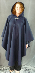 Cloak:1976, Cloak Style:Cape / Ruana, Cloak Color:Navy Blue Herringbone, Fiber / Weave:Wool Herringbone, Cloak Clasp:Triple Medallion, Hood Lining:Unlined, Back Length:47", Neck Length:21.5", Seasons:Winter, Fall, Spring, Note:This navy blue wool herringbone ruana <br>features a full unlined hood and is finished off<br> with a Triple Medallion hook-and-eye clasp. Simplicity and elegance in perfect harmony!<br> A cross between a cape and a cloak, a ruana is a great way <br>to keep warm when frequent, unhindered use of your arms <br>is needed. Ruanas make great driving cloaks!.