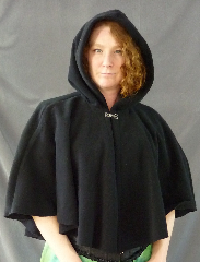 Cloak:1999, Cloak Style:Full Circle Short Cloak, Cloak Color:Black, Fiber / Weave:WindPro Fleece, Cloak Clasp:Plain Rope<br>Hook & Eye, Hood Lining:Self-lining, Back Length:25", Neck Length:20", Seasons:Winter, Fall, Spring, Note:WindPro Fleece short full circle cloak.<br>The fabric is 60-70% wind resistant and sheds water.<br>Features full size, unlined hood to fit an adult<br>or could be used for a child.<br>Closes with a Plain Rope hook-and-eye clasp..