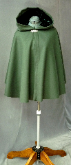Cloak:2123, Cloak Style:Full Circle Short Cloak, Cloak Color:Green, Fiber / Weave:Wool Melton, Cloak Clasp:Bavarian - Silvertone, Hood Lining:Green Rayon Acetate Velvet, Back Length:29", Neck Length:20", Seasons:Winter, Fall, Spring, Note:This short cloak is a full  circle.<br>The smaller neck makes this a good choice for a child or small person.<br>It is made from a deep green wool melton<br>finished with a silvertone Bavarian style hook and eye clasp.<br>The hood, lined with dark green velvet, adds a dash of elegance.<br>Dry Clean..