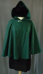 Cloak:2403, Cloak Style:Full Circle Short Cloak, Cloak Color:Green, Fiber / Weave:Fleece, Cloak Clasp:Fleur de Lis, Hood Lining:Self-lining, Back Length:27", Neck Length:23", Seasons:Fall, Spring, Note:This dark green cloak goes back to the basics.<br>It's a full circle cloak, made from a very soft,<br>light weight polyester fleece.<br>Finished with a simple pewter Plain Rope<br>style hook and eye clasp, it provides<br>a warmth with very little weight.<br>Suitable for indoor wear, late spring,  early fall,<br>or cool summer evenings..