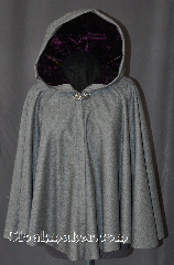 Cloak:2915, Cloak Style:Full Circle Short Cloak, Cloak Color:Grey, Fiber / Weave:100% Wool, Cloak Clasp:Vale, Hood Lining:Amethyst Crushed Velvet, Back Length:27", Neck Length:20.5", Seasons:Fall, Spring, Note:This short full circle cloak<br>is perfect for adding just<br>a touch of drama and elegance.<br>Made from a heathered grey<br>100% wool. The hood is<br>lined with crushed<br>velvet amethyst.<br>Then accented with a classic<br>Vale hook-and-eye clasp.<br>Dry Clean only.