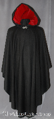Cloak:2935, Cloak Style:Cape / Ruana, Cloak Color:Black, Fiber / Weave:Wool Blend Coating, Cloak Clasp:Vale, Hood Lining:Cherry Red Cotton Velveteen, Back Length:49", Neck Length:23", Seasons:Fall, Spring, Note:A cross between a cape and a cloak,<br>a ruana is a great way to keep warm<br>while frequent, unhindered use of<br>your arms is needed.<br>Ruanas make great driving cloaks!<br>This gorgeous wool blend is<br>accented with a cherry red<br>cotton velveteen hood lining<br>and silver vale clasp.<br>Dry Clean Only.