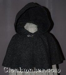 Cloak:2948, Cloak Style:Shaped Shoulder Cloak - Short, Cloak Color:Heathered Charcoal Grey, Fiber / Weave:80% Wool / 20% Nylon, Cloak Clasp:Antiquity, Hood Lining:Unlined, Back Length:16", Neck Length:20", Seasons:Fall, Spring, Note:Perfect Starter cloak for a child<br>or a fashionable alternative<br>to a shawl.<br>This dark grey short cloak<br>is made of a heathered woo<br>blend and feels like felt.<br>The silver tone antiquity<br>hook and eye clasp completes<br>the look for cool evenings.<br>A fun addition to any wardrobe.<br>Dry Clean Only.<br>Pictured with robe R285 sold separately..