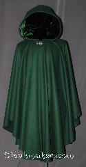 Cloak:2963, Cloak Style:Cape / Ruana, Cloak Color:Forest Green, Fiber / Weave:100% Wool, Cloak Clasp:Vale, Hood Lining:Green Velvet, Back Length:44", Neck Length:22", Seasons:Fall, Spring, Southern Winter, Note:This green ruana cloak is a gorgeous<br>forrest green with matching velvet lining.<br>Made of mid-weight with shortened sides<br>allowing for a a wide range of movement.<br>Perfect for driving on cold days.<br>Accented with a Silver tone Vale hook-and-eye clasp.<br>Dry Clean only..