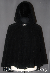 Cloak:3050, Cloak Style:Shaped Shoulder Cloak - Short, Cloak Color:Black, Fiber / Weave:Windblock Polar Fleece, Cloak Clasp:Vale, Hood Lining:Unlined, Back Length:30", Neck Length:21", Seasons:Winter, Southern Winter, Fall, Spring, Note:Perfect starter cloak for a child<br>or adult on cold winter<br>evenings with a weighted<br>protection from winter winds.<br>Extra caution recommended<br>when crossing streets,<br>air will be blocked and<br>sounds will be muffled.<br>Partially water resistant.<br>Adorned with a silver tone<br>vale hook-and-eye clasp.<br>Machine Washable.<br>Never dry clean.