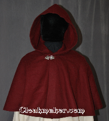 Cloak:3062, Cloak Style:Shaped Shoulder Cloak - Short, Cloak Color:Maroon, Fiber / Weave:100% Wool, Cloak Clasp:Vale, Hood Lining:Unlined, Back Length:18", Neck Length:22", Seasons:Fall, Spring, Note:This short shape shoulder cloak<br>is perfect for adding just a touch<br>of drama and elegance.<br>Made from a maroon 100% wool<br>this cloak is unlined, and finished off<br>with a classic Vale hook-and-eye clasp.<br>Dry Clean only.