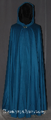Cloak:3364, Cloak Style:Full Circle Cloak, Cloak Color:Teal Blue, Fiber / Weave:25%  Cashmere, Cloak Clasp:Vale, Hood Lining:Black Silk Velvet, Back Length:55", Neck Length:23.5", Seasons:Fall, Spring, Southern Winter, Note:A gorgeous soft teal blue<br>full circle cloak is the ideal piece<br>for any king or queen.<br>Accented with a black silk velvet<br>hood lining for a<br>luxurious feel and vale clasp.<br>Dry clean only.