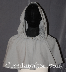 Cloak:3439, Cloak Style:Shape shoulder short, Cloak Color:Light Grey, Fiber / Weave:100% Wool, Cloak Clasp:Triskelion shank button, Hood Lining:Unlined, Back Length:14", Neck Length:21", Seasons:Fall, Spring, Summer, Note:A Perfect starter cloak for a child or a<br>fashionable alternative to a shawl.<br>This light grey short capelet is made<br>of a lightweight 100% wool fabric.<br>The simple celtic swirl and<br>loop clasp allows for<br>quick dressing on cool evenings.<br>Dry Clean Only..