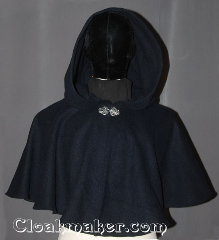 Cloak:3491, Cloak Style:Full Circle Cloak Short, Cloak Color:Navy Blue, Fiber / Weave:Wool Blend, Cloak Clasp:Vale, Hood Lining:Unlined, Back Length:19", Neck Length:20", Seasons:Winter, Southern Winter, Fall, Spring, Note:This navy blue short full circle cloak<br>will keep you warm on chilly winter nights.<br>Perfect for a child to grow with or<br>a warm shrug for a night on the town.<br>The silver-tone Vale clasp is the final touch<br>on this functional and elegant cloak.<br>Spot or dry clean only..