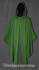 Cloak:3492, Cloak Style:Shape shoulder Ruana raincoat w/ backpack pleat, Cloak Color:Green, Fiber / Weave:3 layer ultrex, Cloak Clasp:Vale, Hood Lining:Unlined grey fleece interior<br>double sided fabric, Back Length:44"back<br>27" overarm, Neck Length:22.5", Seasons:Winter, Southern Winter, Fall, Spring, Note:You will be singing in the rain on your way<br>to school or hiking in this waterproof<br>ultrex ruana with a added room for a backpack.<br>The 3 layered fabric has a<br>green crosshatched outer lining<br> and an absorbent grey fleece interior,<br>with a thin windblocking material in between.<br>The added pleat in back allows for you<br>and your supplies to travel underneath<br>your cloak's protection with little<br> carefice to your comfort.<br>A cross between a cape and a cloak,<br>a ruana is a great way to keep warm<br>when frequent, unhindered use of<br> your arms is needed.<br>Ruanas make great driving cloaks!<br>Machine wash cold..