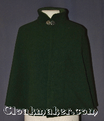 Cloak:3554, Cloak Style:Shape Shoulder Collared with pockets, Cloak Color:Forrest Green, Fiber / Weave:Wool Cashmere Blend, Cloak Clasp:Vale, Hood Lining:Light Green Collar lining<br>hoodless, Back Length:24.25", Neck Length:18.75", Seasons:Winter, Southern Winter, Fall, Spring, Note:This sophisticated forest green<br>shape shoulder cloak harkens back to the<br>age of 1950-1960 high fashion.<br>Made of a wool cashmere blend with a<br>lighter green inner collar lining<br>for warmth during bitter winter events.<br>The mandarin collar is secured by a<br>classic pewter vale clasp.<br>Two pockets are hidden on the<br>inside for easy storage of light items <br>Dry clean only..