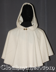 Cloak:3557, Cloak Style:Full Circle Cloak Short, Cloak Color:White / Cream, Fiber / Weave:80% Wool<br>20% Nylon, Cloak Clasp:Unique brass tone leaf heart, Hood Lining:Unlined, Back Length:23", Neck Length:22", Seasons:Fall, Spring, Note:"All the land will be mantled with snow."<br>Roy Bean.<br>This snowy mantle will keep that cool<br>wind off your shoulders for an elegant<br>night out for you or your child.<br>This ivory short cape is ideal for<br>formal fall outdoor events or<br>winter themed indoor galas when you need<br>a little extra warmth.<br>Can be layered on top of other cloaks<br>Spot or dry clean only..
