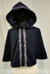 Cloak:3635, Cloak Style:Full Circle Cloak, Cloak Color:Navy Blue, Fiber / Weave:Wool Suiting, Cloak Clasp:Snaps, Hood Lining:Unlined, Back Length:21", Neck Length:18", Seasons:Summer, Spring, Fall, Note:This short full circle cloak is a light<br>navy blue color and secures with<br>a hook and eye.<br>It is paired with the<br>'Stylized Swirl in Gold & Blue' trim.<br>Dry clean only..