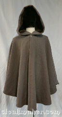 Cloak:3677, Cloak Style:Cape / Ruana, Cloak Color:Grey Taupe, Fiber / Weave:100% wool, Cloak Clasp:Vale, Hood Lining:Light brown velveteen, Back Length:35", Neck Length:20", Seasons:Southern Winter, Fall, Spring, Note:This grey taupe colored shaped shoulder<br>ruana style cloak with a light brown<br>velveteen hood lining<br>and matching interfacing.<br>Made from washed wool with a<br>novelty weave stripe.<br>Machine wash warm on delicate cycle.<br>Tumble dry on low..