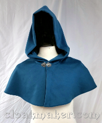 Cloak:3690, Cloak Style:Shaped Shoulder Cloak, Cloak Color:Soft Teal Blue, Fiber / Weave:80% wool, 20% nylon, Cloak Clasp:Vale, Hood Lining:Unlined, Back Length:12", Neck Length:23", Seasons:Winter, Southern Winter, Spring, Fall, Note:A soft teal blue colored shaped shoulder<br>capelet with a silvertone vale clasp.<br>Made from a very pleasant<br>feeling wool, dry clean only..