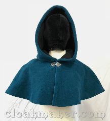 Cloak:3750, Cloak Style:Shaped Shoulder Cloak, Cloak Color:Teal Blue, Fiber / Weave:WindBloc Fleece, Cloak Clasp:Vale, Hood Lining:Self lined with black, Back Length:12", Neck Length:19", Seasons:Winter, Southern Winter, Spring, Fall, Note:Windbloc fleece in a teal blue will<br>keep the wind off your back.<br>Self lined in black, this water resistant<br>shaped shoulder cloak has a<br>silvertone vale clasp to keep you<br>safe and secure..