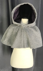 Cloak:3853, Cloak Style:Shaped Shoulder, Cloak Color:Heathered Grey, Fiber / Weave:Partly felted Brushed 100% Wool Melton, Cloak Clasp:Vale, Hood Lining:Dusty Plum Purple Cotton Velvet, Back Length:15", Neck Length:21", Seasons:Southern Winter, Spring, Fall, Winter, Note:A delightful capelet to warm your<br>shoulders, this heathered dove grey<br>shaped shoulder cloak is made of<br>partly felted brushed wool coating<br>and has a dark plum<br>velvet hood lining and a<br>silver-tone vale clasp.