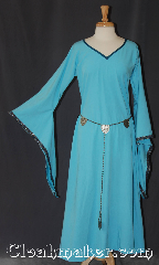 Gown ID:G948, Gown Color:light blue, Style:12th Century<br>(shown with<br>Silvertone Plated Shell Shield Accolade<br>Belt Item #BT0020BZ-ST <br>sold separately), Sleeve:Long drop sleeve<br>with red and amber celtic knot<br>on black edge, Trim:Running Mosaic Vine sleeve, Neckline Type:V-Neck with Blue bias trim, Fabric:Linen look rayon poly, Hip:Neck 24", Sleeve Length:28.5", Back Length:53.5".