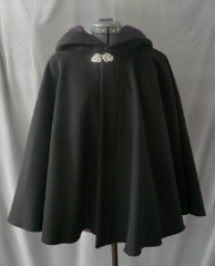 Cloak:1761, Cloak Style:Full Circle Short Cloak, Cloak Color:Black, Fiber / Weave:Corded Wool - vert stripe, Cloak Clasp:Vale, Hood Lining:Dusty Dark Plum Cotton Velvet, Back Length:27.5", Neck Length:23", Seasons:Winter, Fall, Spring.