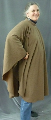 Cloak:2406, Cloak Style:Cape / Ruana with Collar, Cloak Color:Heathered Light Brown with Grey, Fiber / Weave:80% wool 20% nylon, Cloak Clasp:Plain Rope<br>Hook & Eye, Hood Lining:N/A, Back Length:46", Neck Length:21", Seasons:Spring, Fall, Note:This cape / ruana cloak is made from a wool/nylon blend in a<br>heathered light brown with a touch of grey that will blend well in the woods<br>and look decent between cleanings.<br>
Finished with a silvertoned plain rope hook-and-eye clasp.<br>A cross between a cape and a cloak, a ruana is a great way <br>to keep warm while frequent, unhindered use of your arms <br>is needed. Ruanas make great driving cloaks!.