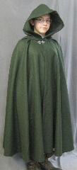 Cloak:2605, Cloak Style:Fuller Half Circle, Cloak Color:Green, Fiber / Weave:Felted Medium Weight Melton, Cloak Clasp:Vale, Hood Lining:Dark Olive Moleskin, Back Length:42", Neck Length:21", Seasons:Winter, Fall, Spring, Note:Note, the model is 4' 10".