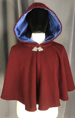 Cloak:3858, Cloak Style:50"-55" Circle Cloak, Cloak Color:Maroon Red, Fiber / Weave:Plush 100% Wool Coating, Cloak Clasp:Triple Medallion, Hood Lining:Medium Blue Cotton Velvet, Back Length:20", Neck Length:22.5", Seasons:Southern Winter, Spring, Fall, Winter, Note:This lovely cloak is made from a<br>beautiful maroon plush wool coating<br>in a 80/20 wool/nylon blend.<br>Finished with a blue cotton<br>velvet hood lining and silver tone<br>triple medallion clasp.<br>Dry clean only.
